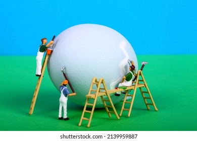 Conceptual Image Of Miniature Figure People Painting A Hens Egg For Easter