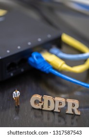 Conceptual Image Of Miniature People  With Ethernet Cables And GDPR Wooden Text. Selective Focus.