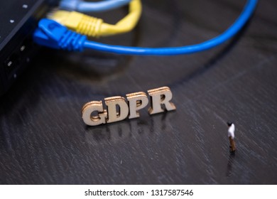 Conceptual Image Of Miniature People  With Ethernet Cables And GDPR Wooden Text. Selective Focus.