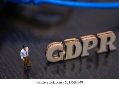 Conceptual Image Of Miniature People  With Ethernet Cables And GDPR Wooden Text. Selective Focus.