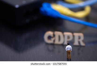 Conceptual Image Of Miniature People  With Ethernet Cables And GDPR Wooden Text. Selective Focus.