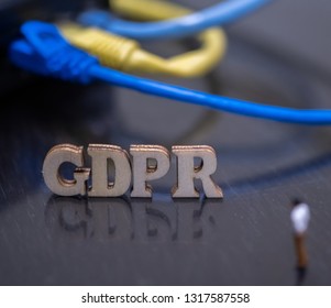 Conceptual Image Of Miniature People  With Ethernet Cables And GDPR Wooden Text. Selective Focus.