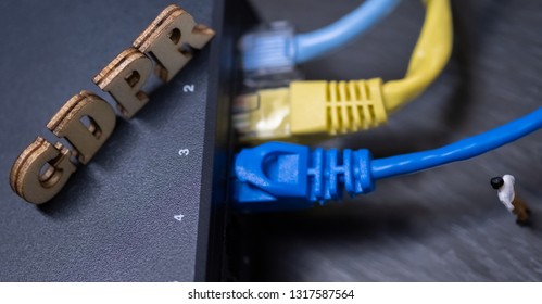 Conceptual Image Of Miniature People  With Ethernet Cables And GDPR Wooden Text. Selective Focus.