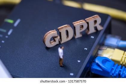 Conceptual Image Of Miniature People  With Ethernet Cables And GDPR Wooden Text. Selective Focus.