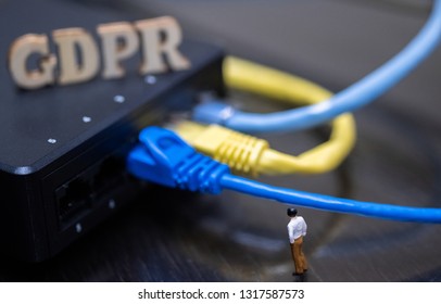 Conceptual Image Of Miniature People  With Ethernet Cables And GDPR Wooden Text. Selective Focus.