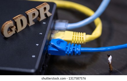 Conceptual Image Of Miniature People  With Ethernet Cables And GDPR Wooden Text. Selective Focus.