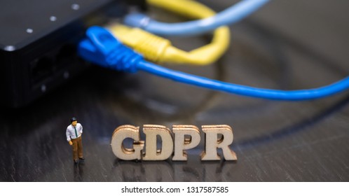 Conceptual Image Of Miniature People  With Ethernet Cables And GDPR Wooden Text. Selective Focus.