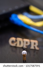 Conceptual Image Of Miniature People  With Ethernet Cables And GDPR Wooden Text. Selective Focus.