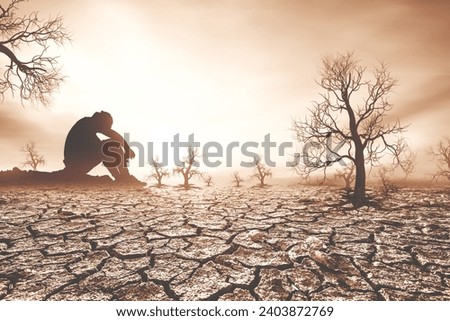 Conceptual image of people who are in despair because of drought and global warming, unable to grow crops.