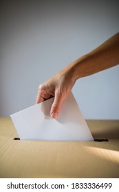 Conceptual image of a person voting, casting a ballot at a polling station, during elections. - Shutterstock ID 1833336499