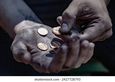 Conceptual image: poverty, hunger, injustice and social inequality. A man counts coins to buy food.