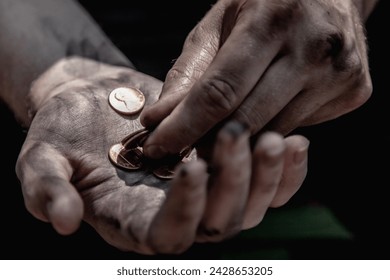 Conceptual image: poverty, hunger, injustice and social inequality. Close up man counts coins to buy food.