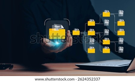 Conceptual image representing a digital data management system, network, or cloud computing service, with holographic documents and a folder displayed above a hand.