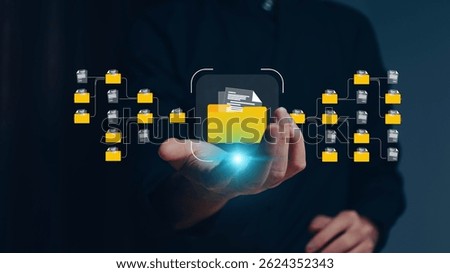 Conceptual image representing a digital data management system, network, or cloud computing service, with holographic documents and a folder displayed above a hand.