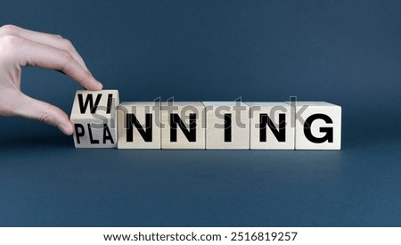 A conceptual image representing the idea of reaching goals through effective planning. A hand turns a wooden block to reveal the word 'winning', symbolizing the outcome of a well-executed strategy