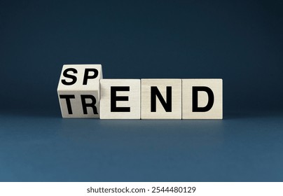 Conceptual image representing idea that consumer spending is often influenced by trends. Wooden blocks with words Trend and Spend symbolize direct relationship between trends and consumer behavior