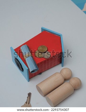 Conceptual image of small house, keys, penny and wooden block mean properties for sales