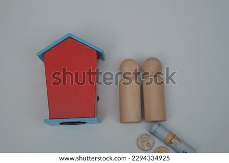 Conceptual image of small house, keys, penny and wooden block mean properties for sales