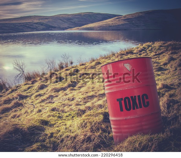 Conceptual Image Of A Toxic Waste Barrel Or
Drum Near Water In The 
Countryside