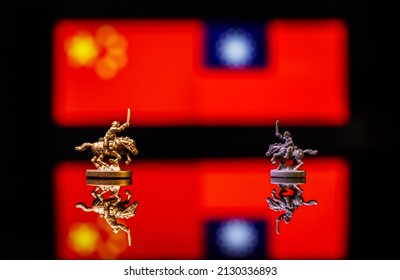 Conceptual image of war between China and Taiwan using toy soldiers and national flags on a reflective background - Powered by Shutterstock