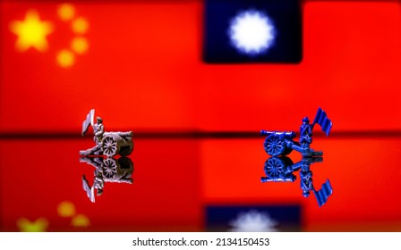 Conceptual image of war between China and Taiwan using toy soldiers and national flags on a reflective background - Powered by Shutterstock