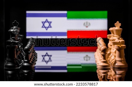 Conceptual image of war between Israel and Iran using chess pieces and national flags on a reflective background