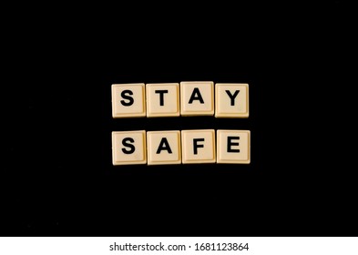 Conceptual image a word "STAY SAFE" on scrabbles tiles on black background. Selective focus. - Shutterstock ID 1681123864
