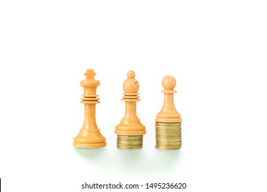 Conceptual And Metaphorical Photography With Chess Pieces And Coins On White Background Showing The Concept Of Social Equity.