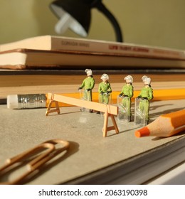 Conceptual Miniature Photo Scene Of Police Guard On The Office Table With Unfocus Book And Blurred Stationery Stuff.