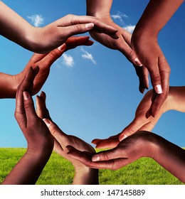 Conceptual Peace And Unity Symbol Of Different Black African Ethnicity Hands Making A Circle Together On Blue Sky And Green Grass Background