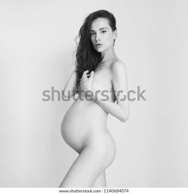 Conceptual photo of elegant naked pregnant woman. 