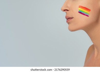 Conceptual Photo Of Female Face With Colorful Painted Rainbow On Cheek. LGBT Flag. Equality And Support Of Diversities To People. Copy Space.
