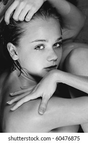 Conceptual Photo Of A Woman Curled Up In A Fetal Position In The Water.