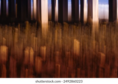 Conceptual photographic artwork that uses intentional camera movement and a slow shutter speed. The scene is the underneath of a seaside pier, vertically panning the camera. - Powered by Shutterstock