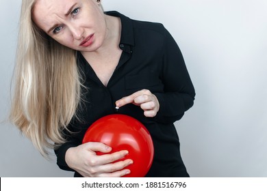 Conceptual Photography. The Woman Holds A Red Ball Near His Belly, Which Symbolizes Bloating And Flatulence. Then She Brings A Needle To It To Burst The Balloon And Thus Get Rid Of The Problem.