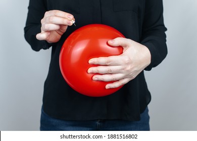 Conceptual Photography. The Woman Holds A Red Ball Near His Belly, Which Symbolizes Bloating And Flatulence. Then She Brings A Needle To It To Burst The Balloon And Thus Get Rid Of The Problem.