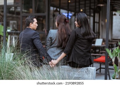 Conceptual Portrait Of People Cheating In Working Environment. Man And Woman Hold Hand Betraying His Partner