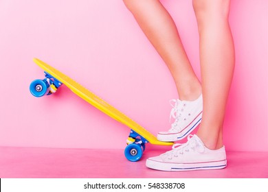 Conceptual shooting of girl's feet standing on the skateboard - Powered by Shutterstock