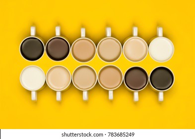 A conceptual shot and milk/tea/coffee in cups arranged in manner which creates gradient effect colours  Lighter to darker shades drinks  The image is yellow background