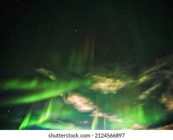 Conceptual shot of stars with aurora and clouds, rotating around the north.