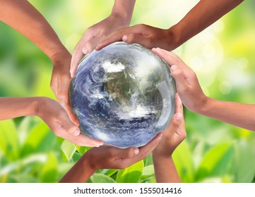 Conceptual symbol of multiracial human hands surrounding the Earth globe. Unity, world peace, humanity concept. World environment day