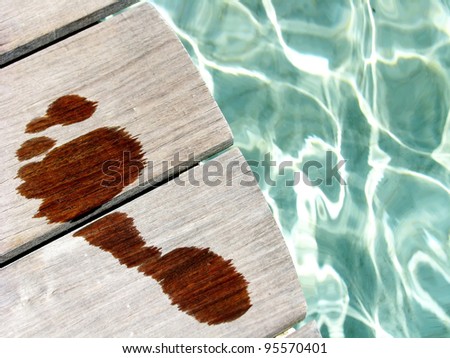 Conceptual wet woman footprint in a spa area / wellness, healthy, relaxing or vacations concepts