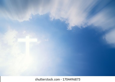 Conceptual wood cross or religion symbol shape over a sky with clouds background  - Shutterstock ID 1704496873