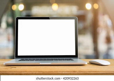 Conceptual workspace, Laptop computer with blank white screen on table, blurred background. - Shutterstock ID 420932263