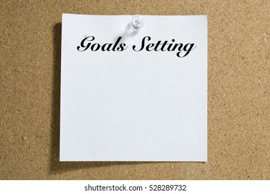 Conceptual,notebook on a white table. open diary and pen Goals Setting words