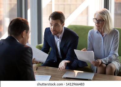 Concerned businesspeople argue with colleague or client dissatisfied with contract terms, mad worried businessman have dispute with business partner unhappy with agreement, claiming money back - Shutterstock ID 1412966483