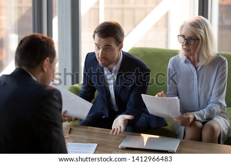 Concerned businesspeople argue with colleague or client dissatisfied with contract terms, mad worried businessman have dispute with business partner unhappy with agreement, claiming money back
