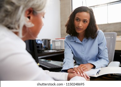 Concerned female analyst counselling senior patient