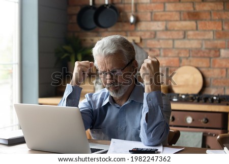 Concerned grey haired mature man calculate household finances, have debt, experiencing financial problem paying bills taxes online feels stressed managing family budget, expenses, expenditures concept