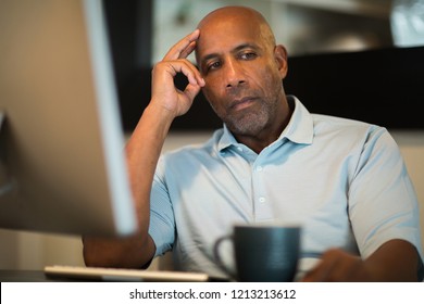 Concerned Man Sitting At His Computer.